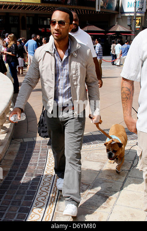 John Legend and his dog at The Grove to film an appearance with Mario Lopez for the entertainment television news programme Stock Photo