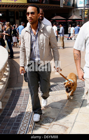 John Legend and his dog at The Grove to film an appearance with Mario Lopez for the entertainment television news programme Stock Photo