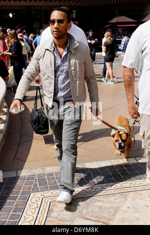 John Legend and his dog at The Grove to film an appearance with Mario Lopez for the entertainment television news programme Stock Photo