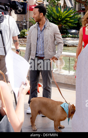 John Legend and his dog at The Grove to film an appearance with Mario Lopez for the entertainment television news programme Stock Photo