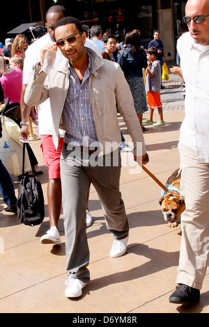 John Legend and his dog at The Grove to film an appearance with Mario Lopez for the entertainment television news programme Stock Photo