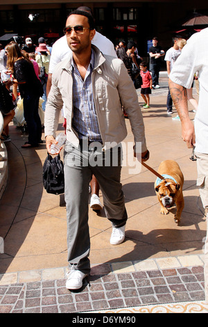 John Legend and his dog at The Grove to film an appearance with Mario Lopez for the entertainment television news programme Stock Photo