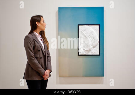 London, UK. 25 April 2013.  Daniela, a Saatchi Gallery employee looks up at a work by Nicholas Deshayes during the press preview of the 'New Order: British Art Today' exhibition opening on the 26th April in London. Credit: Piero Cruciatti/Alamy Live News