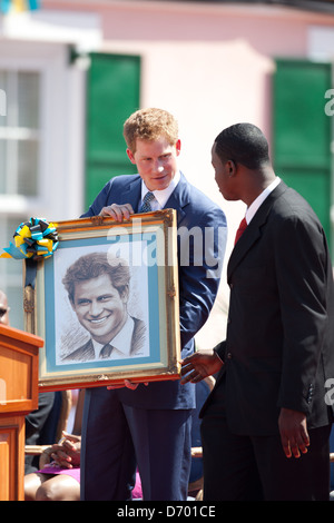 Britain's Prince Harry receives a framed painting of himself by local artist Jamaal Rolle at the opening of the Queen's Diamond Jubilee Exhibition in Rawson Square in Nassau, Bahamas on Sunday (04Mar12). The Prince is on a week-long tour through Central America and the Caribbean acting as an ambassador for Queen Elizabeth II as part of her Diamond Jubilee year. Nassau, Bahamas - 04.03.12 Stock Photo