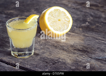 Limoncello Lemon Liqueur on wooden background Stock Photo