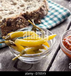 hot peppers and bread on table in close up Stock Photo