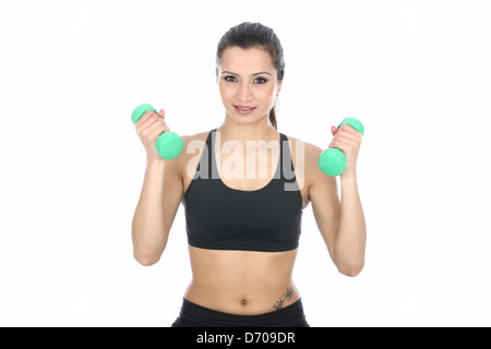 Determined Confident Positive Young Woman Exercising With Dumbbell Weights Isolated Against A White Background With A Clipping Path And Copy Space Stock Photo