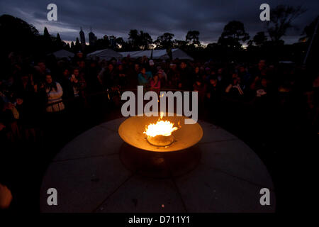 Melbourne Australia. 25th April 2013. Large crowds stand by the eternal flame for the dawn service at the shrine of remembrance in Melbourne on  Anzac Day to pay tribute and remember fallen soldiers Stock Photo