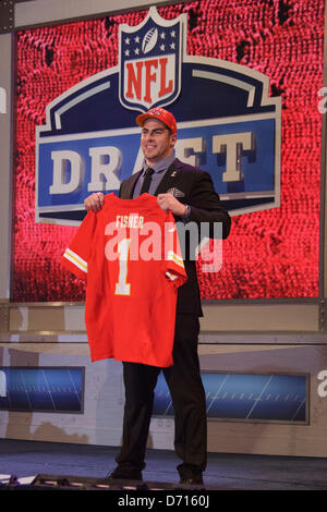 Eric Fisher, offensive tackle from Central Michigan, holds up a Chiefs  Jersey and stands next to NFL Commissioner Roger Goodell after the Kansas  City Chiefs select him as the #1 overall pick