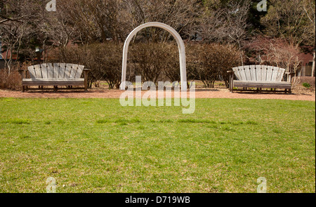 wooden park benches in garden Stock Photo