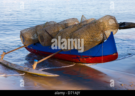 Canoe with fishing basket on the beach, Nosy Komba, Madagascar Stock Photo