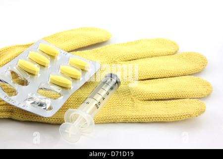 Blister and syringes on the Yellow gloves. Stock Photo