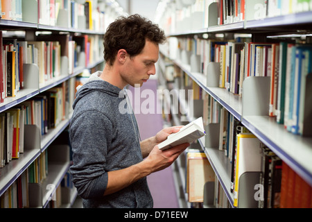 student reading book in library, university education Stock Photo
