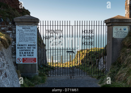 Hartland Point, Hartland, North Devon, England. Trinity House gates and warning signs and Lundy Island through the gates. Stock Photo