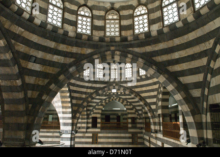 Khan As'ad Pasha, an old Ottoman Khan in Damascus, Syria. Traditional black and white striped ablaq architecture Stock Photo