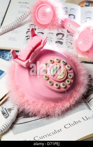 Still Life Pink Fluffy Retro Style Phone with High School Yearbooks Stock Photo