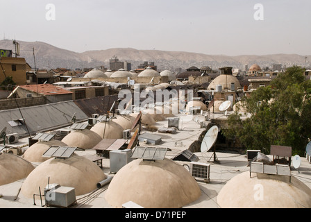 Damascus, Syria. View over the domed roofs of the The Souq Al-Hamadiye covered market to the mountains beyond the city. Stock Photo