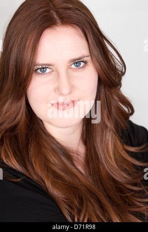 Young Reheaded Woman Staring at Camera Stock Photo
