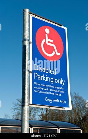 Parking signs for disabled customers at a Tesco Supermarket car park Stock Photo
