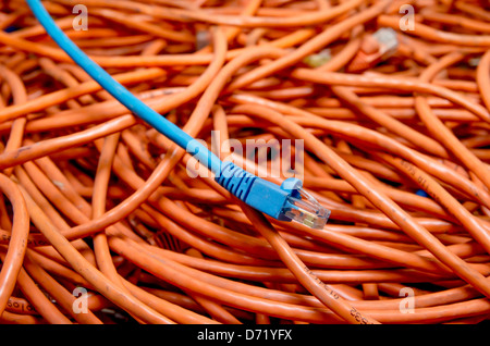 ethernet cables tangled blue and orange Stock Photo