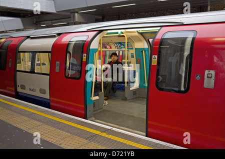Man sitting in a London Tube train. Stock Photo