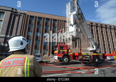 Aberystwyth, UK. 26th April 2013. Flames and smoke were seen coming from the roof at the building's rear and up to 300 staff and 100 visitors were evacuated from the building.  More than 30 firefighters are there, but reports by early Friday evening suggest the fire is less severe.  Senior library staff said it was not known how the fire started but everyone was safe.Credit: Andrew Chittock/Alamy Live News Stock Photo