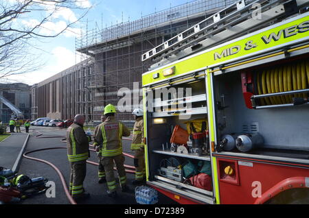 Aberystwyth, UK. 26th April 2013. Flames and smoke were seen coming from the roof at the building's rear and up to 300 staff and 100 visitors were evacuated from the building.  More than 30 firefighters are there, but reports by early Friday evening suggest the fire is less severe.  Senior library staff said it was not known how the fire started but everyone was safe.Credit: Andrew Chittock/Alamy Live News Stock Photo