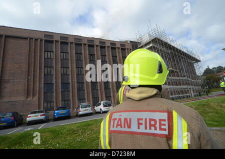 Aberystwyth, UK. 26th April 2013. Flames and smoke were seen coming from the roof at the building's rear and up to 300 staff and 100 visitors were evacuated from the building.  More than 30 firefighters are there, but reports by early Friday evening suggest the fire is less severe.  Senior library staff said it was not known how the fire started but everyone was safe.Credit: Andrew Chittock/Alamy Live News Stock Photo