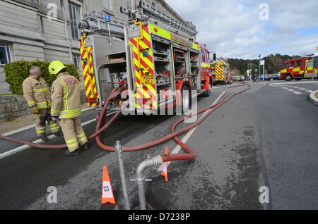 Aberystwyth, UK. 26th April 2013. Flames and smoke were seen coming from the roof at the building's rear and up to 300 staff and 100 visitors were evacuated from the building.  More than 30 firefighters are there, but reports by early Friday evening suggest the fire is less severe.  Senior library staff said it was not known how the fire started but everyone was safe.Credit: Andrew Chittock/Alamy Live News Stock Photo