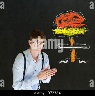 Evil sneaky business man, student or teacher with thought thinking chalk nuclear bomb cloud on blackboard background Stock Photo