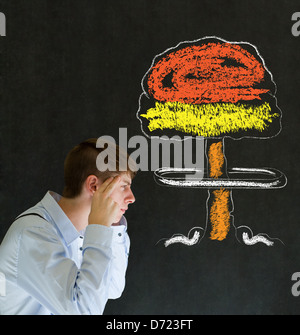 Business man, student or teacher with thought thinking chalk nuclear bomb cloud on blackboard background Stock Photo