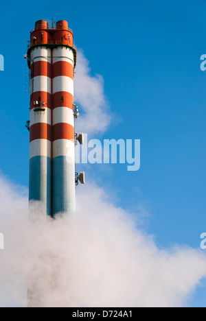 Smoke surrounding industrial chimneys Stock Photo