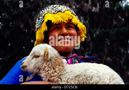 Girl in native dress holding lamb .Pisac.Peru. Stock Photo