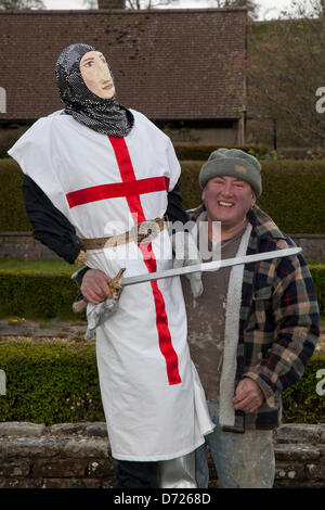 Peter Stirzakier, 65 holding St George at the Wray Scarecrow Festival, established 1995 with wacky scarecrows constructed by the villagers to raise funds for charities, including the church and local school. The theme for 2013 is “I read – Books”  a ‘cultural’ highlight of the Lune Valley's calendar.  Thousands of visitors come to the village to admire the skill and humour of the local residents and it really is a great display of community spirit. Stock Photo