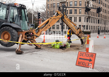 Workers repair underground problems on Beacon Street in Brookline, Massachusetts, near Coolidge Corner. Stock Photo