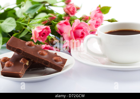Flowers, cup of coffee and sweets. Closeup Stock Photo
