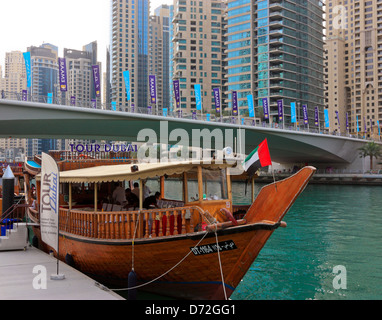 Restaurant and Tourist Cruise Boat in Traditional Dhow Design expecting visitors, Dubai Marina, United Arab Emirates, UAE Stock Photo