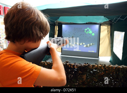Berlin, Germany, boy playing a computer game with a gun Stock Photo