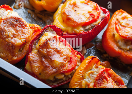 Stuffed bell peppers on black baking pan Stock Photo