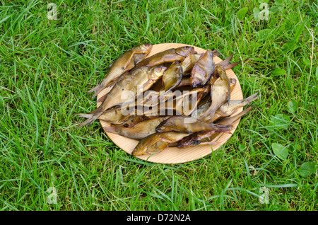 closeup of straw bale in agriculture field and heavy truck move on road. Stock Photo