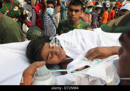 Savar, Bangladesh. April 27, 2013. - Rescue workers carry out a female surivor who has been rescued after 78 hours from the collapsed building at Savar, Bangladesh 27 April 2013. Death toll rises to 341 of the eight-storey building Rana Plaza which collapsed at Savar, outside Dhaka, Bangladesh, 25 April 2013. Many more were still trapped in the remains of the building, which also contained shops and offices, and the army had been called in to help with rescue operations, police said. (Credit Image: Credit:  Monirul Alam/ZUMAPRESS.com/Alamy Live News) Stock Photo