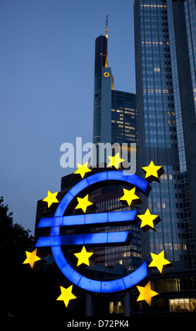 Frankfurt, Germany, the illuminated euro sculpture in front of the Tower of the ECB euro Stock Photo