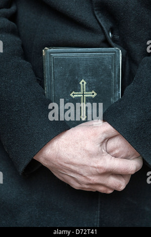 Priest with a bible-close-up Stock Photo