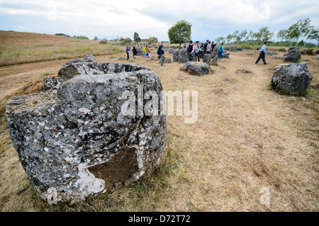 PHONSAVAN, Laos — Some of the mysterious stone jars at Site 1 of the Plain of Jars in north-central Laos. Much remains unknown about the age and purpose of the thousands of stone jars clustered in the region. Most accounts date them to at least a couple of thousand years ago and theories have been put forward that they were used in burial rituals. Stock Photo