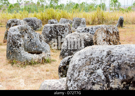 PHONSAVAN, Laos — Stone jars at Site 1 of the Plain of Jars in north-central Laos. Much remains unknown about the age and purpose of the thousands of stone jars clustered in the region. Most accounts date them to at least a couple of thousand years ago and theories have been put forward that they were used in burial rituals. Stock Photo