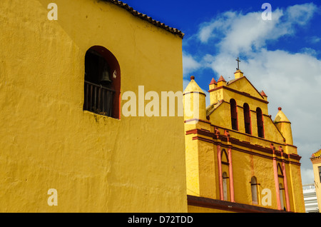 Old yellow colonial church in San Cristobal de las Casas with beautiful blue sky in Chiapas, Mexico Stock Photo