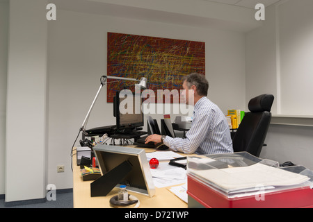 Businessman working late in his office Stock Photo