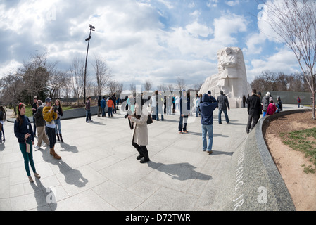 WASHINGTON DC, USA - Tourists visiting the Martin Luther King Memorial in Washington DC. At right is a statue of King sculpted by Lei Yixin, part of a section of the memorial dubbed the Stone of Hope. Stock Photo