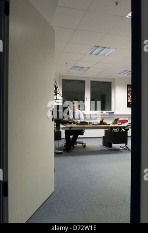 Businessman working late in his office Stock Photo