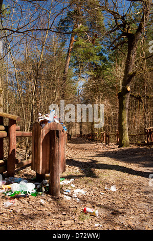 Paper and plastic garbage in the forest Stock Photo